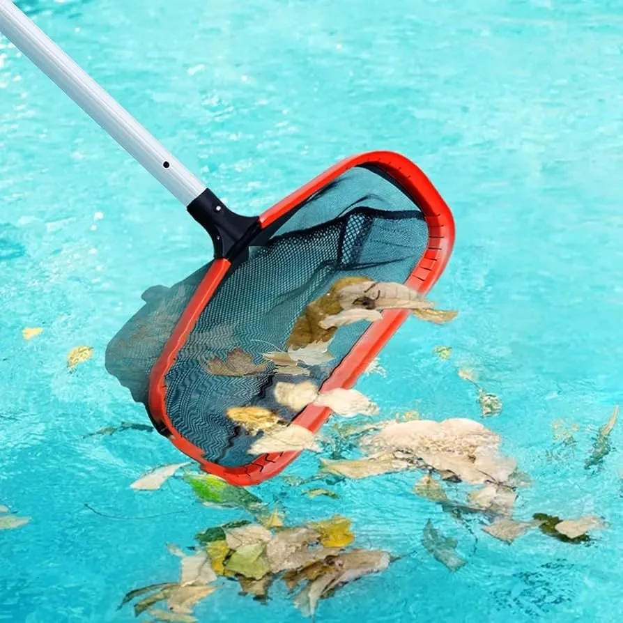 A pool skimmer with leaves and debris in the water.