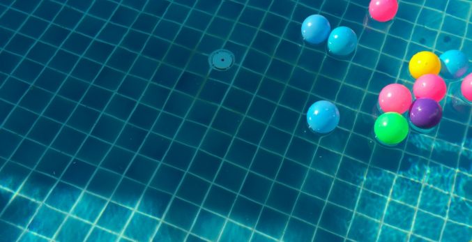 A bunch of colorful balls floating on the pool