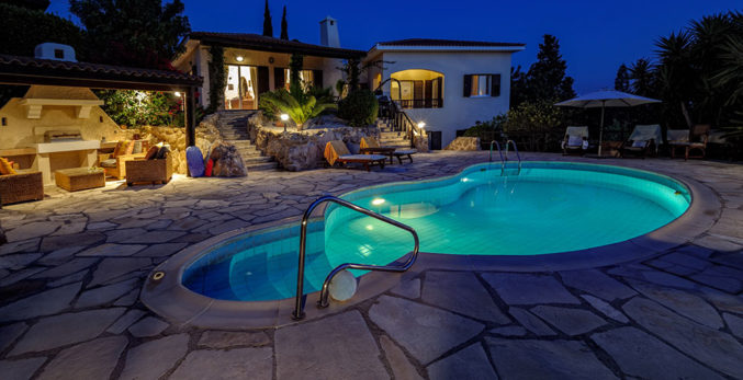 A beautiful house with a large pool in front