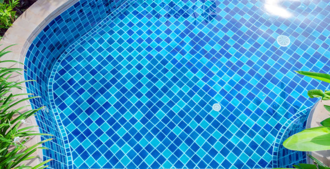 A closeup look of a pool with blue tiles
