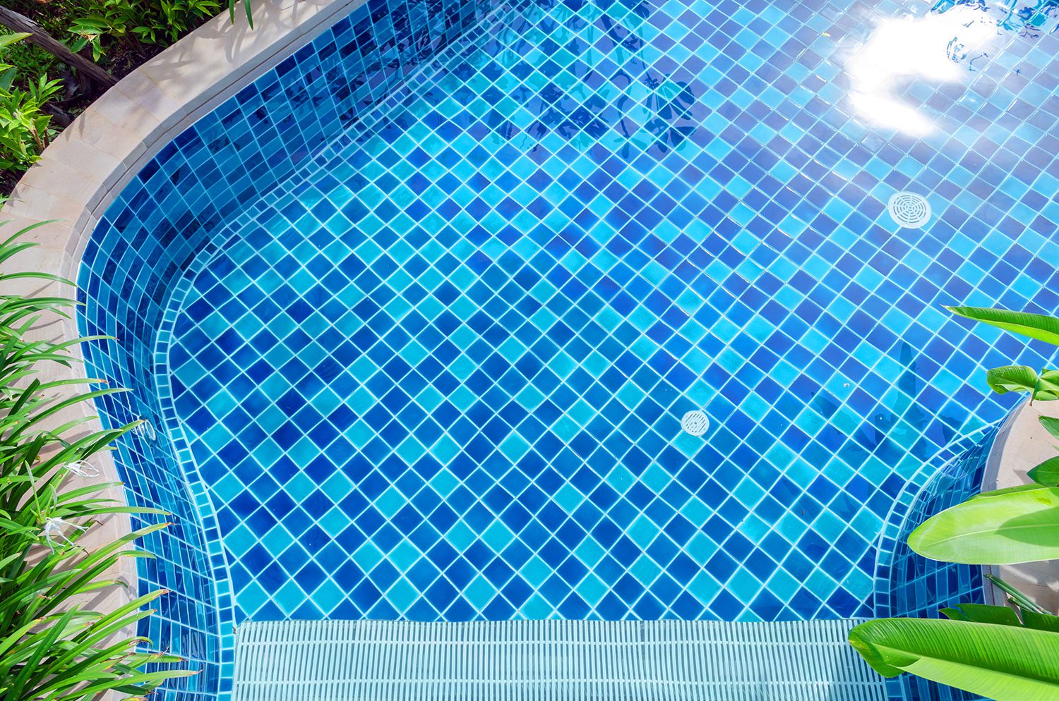 A closeup look of a pool with blue tiles